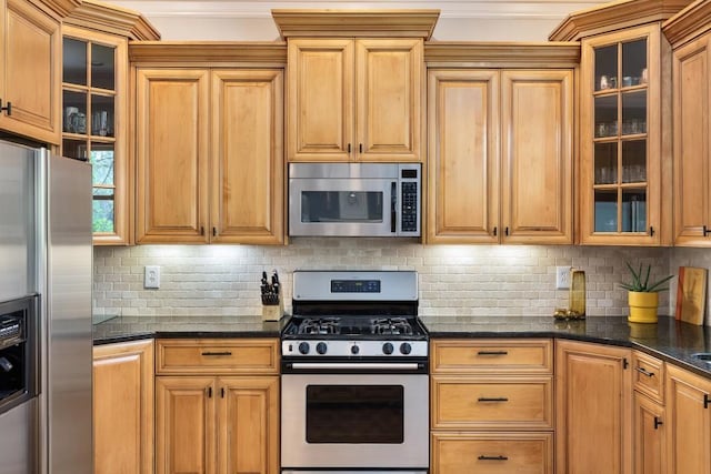 kitchen with glass insert cabinets, tasteful backsplash, and stainless steel appliances