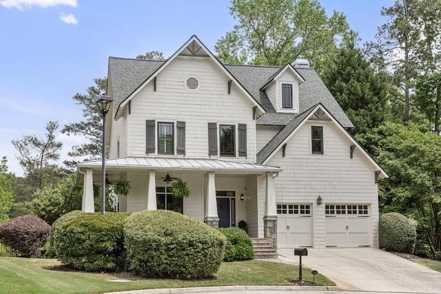 view of front of property with roof with shingles, an attached garage, a porch, a standing seam roof, and driveway