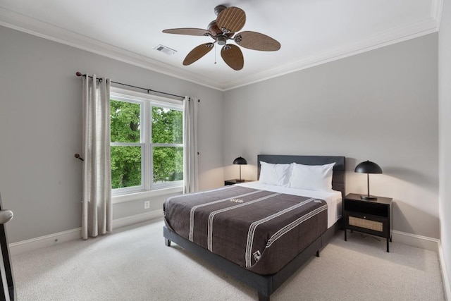 carpeted bedroom featuring baseboards, ornamental molding, ceiling fan, and visible vents
