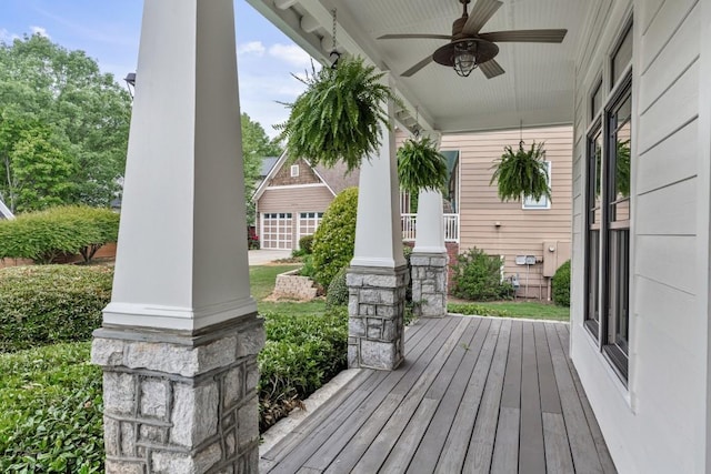 wooden terrace with covered porch and a ceiling fan