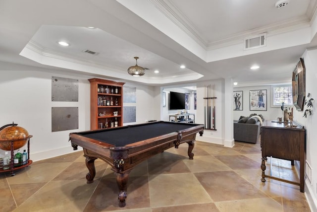 recreation room with ornamental molding, a tray ceiling, and visible vents