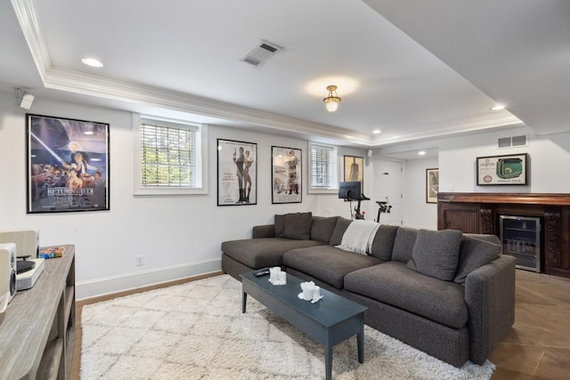 living area with visible vents, recessed lighting, crown molding, and a tray ceiling