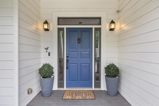 view of exterior entry featuring covered porch