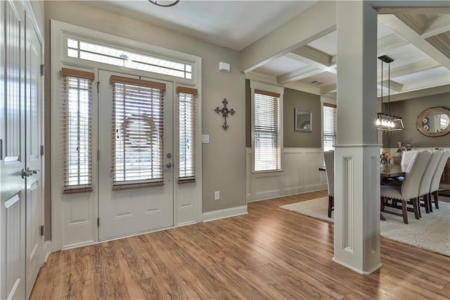 foyer with plenty of natural light, beamed ceiling, wood-type flooring, and coffered ceiling