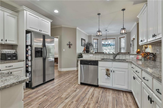 kitchen featuring white cabinets, kitchen peninsula, stainless steel appliances, and tasteful backsplash