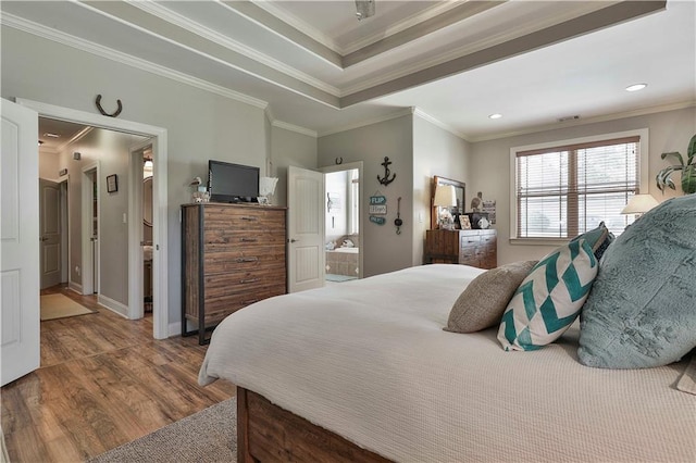 bedroom featuring hardwood / wood-style floors, connected bathroom, and ornamental molding