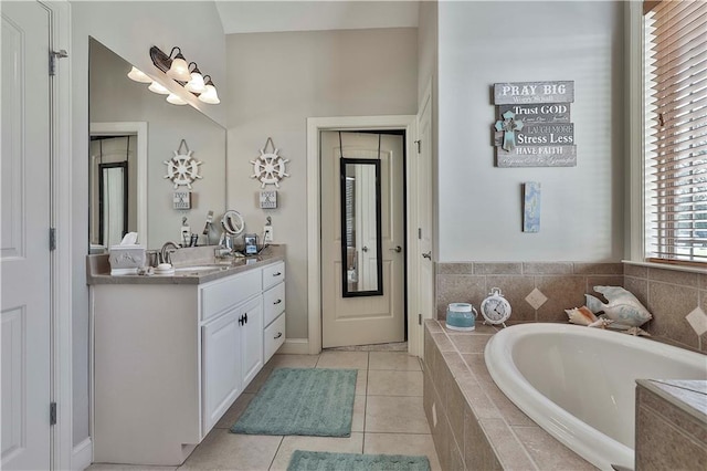 bathroom featuring vanity, tiled bath, and tile patterned floors