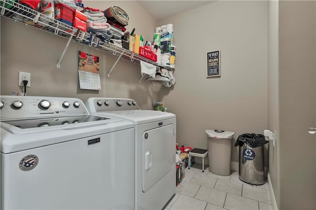 laundry area featuring light tile patterned flooring and washing machine and dryer