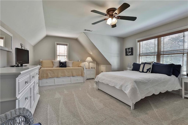 carpeted bedroom with ceiling fan and lofted ceiling