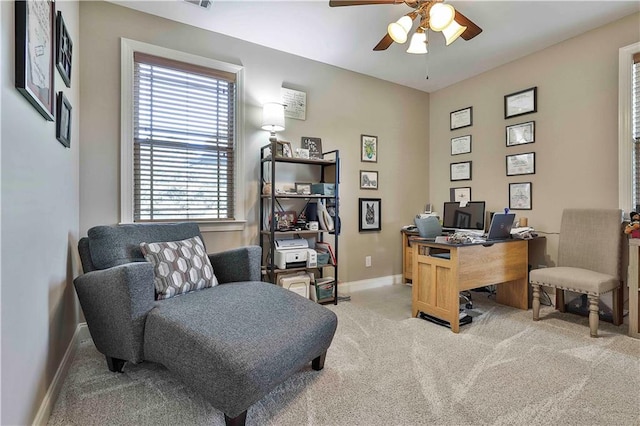 office space featuring light carpet and ceiling fan