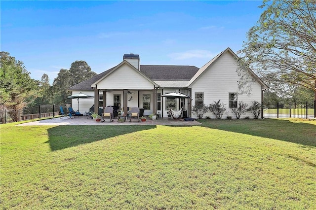 rear view of house with a lawn, a patio area, and ceiling fan