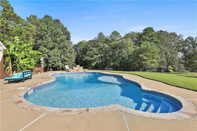 view of swimming pool featuring a yard and a patio