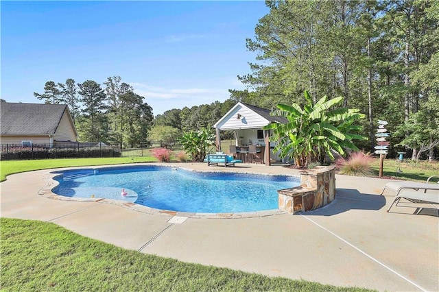 view of swimming pool with a patio area, a bar, and a yard