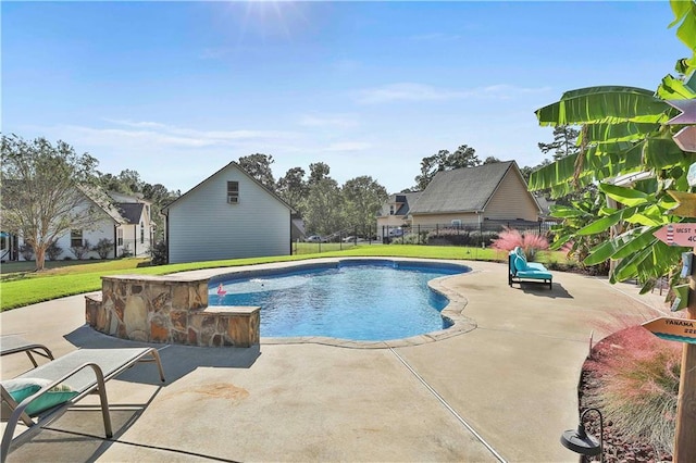 view of swimming pool featuring a yard and a patio