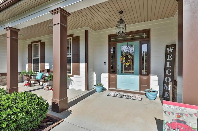 view of exterior entry with a porch