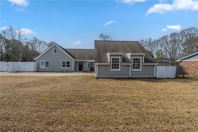 rear view of house with a yard