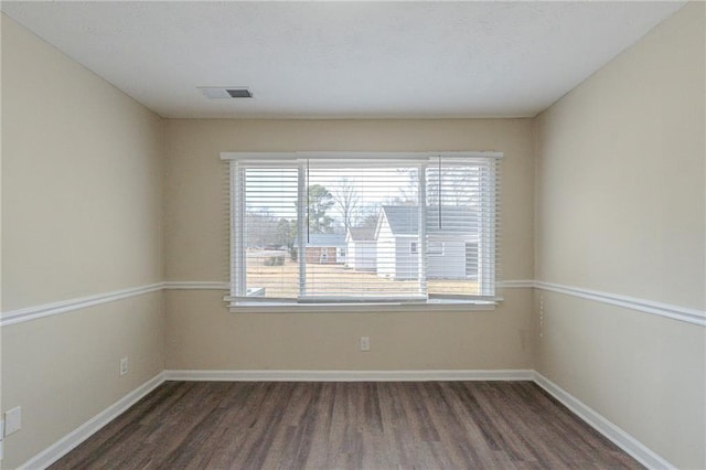 spare room featuring dark wood-type flooring