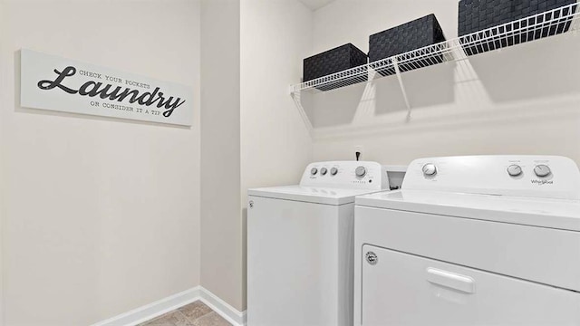 laundry room with baseboards, independent washer and dryer, and laundry area