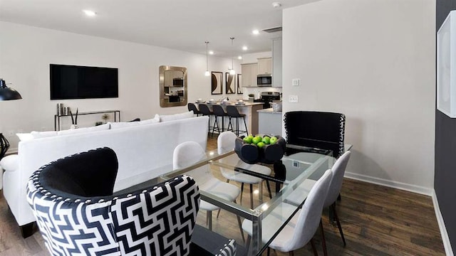 dining room with visible vents, recessed lighting, baseboards, and wood finished floors