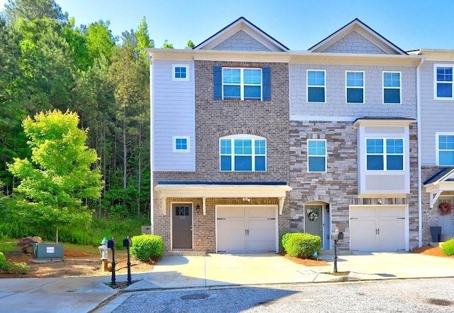 1005 Belfry Ter, Fairburn, GA 30213 - multi unit property with driveway, an attached garage, and stone siding
