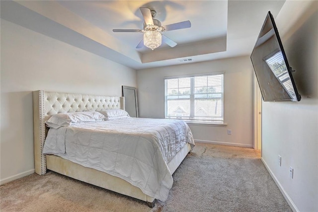 1005 Belfry Ter, Fairburn, GA 30213 - bedroom featuring carpet floors, multiple windows, a tray ceiling, and baseboards