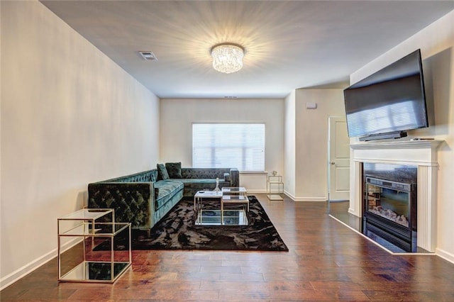 1005 Belfry Ter, Fairburn, GA 30213 - living room with a glass covered fireplace, wood finished floors, and baseboards