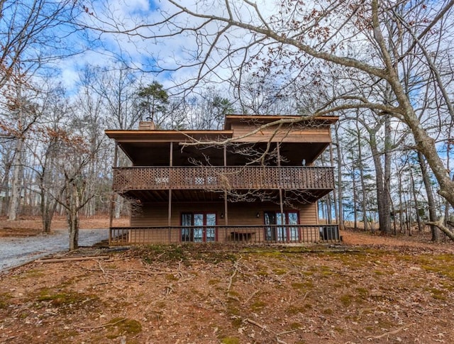 rear view of house with a wooden deck