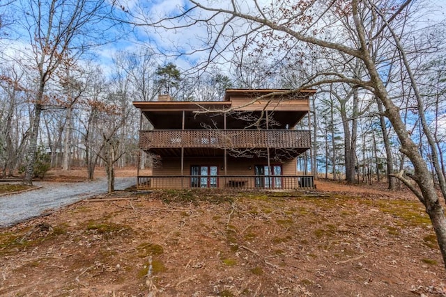 rear view of house featuring a deck