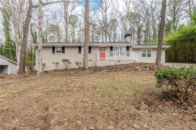 single story home with crawl space, covered porch, a chimney, and brick siding