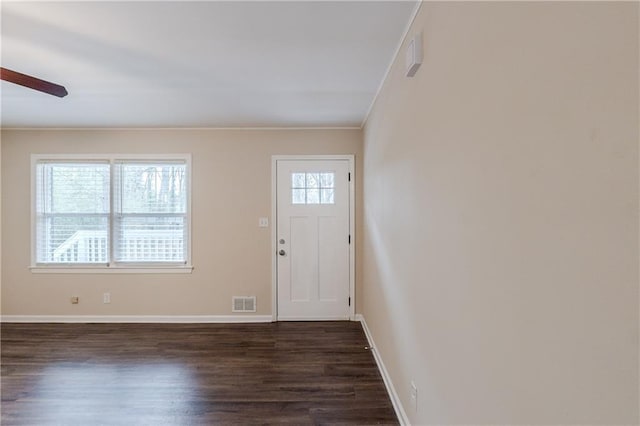 foyer featuring a ceiling fan, dark wood-style flooring, visible vents, and baseboards