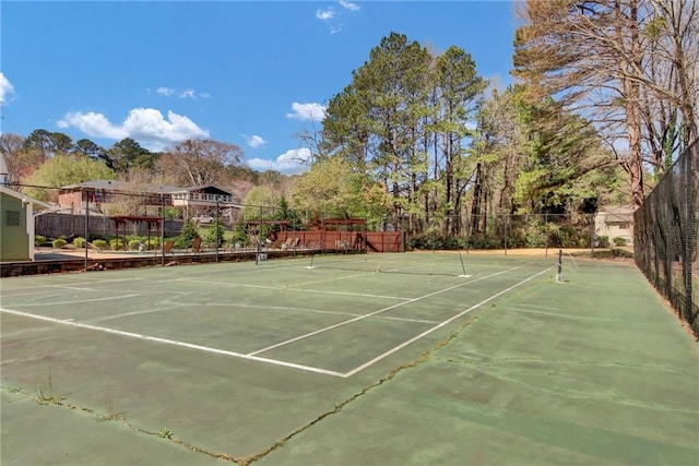 view of sport court featuring fence