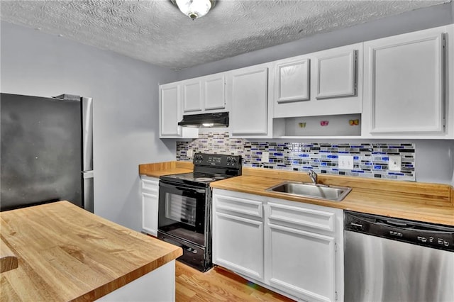 kitchen featuring light wood finished floors, stainless steel appliances, open shelves, a sink, and butcher block countertops