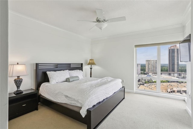 bedroom with carpet flooring, ornamental molding, and baseboards