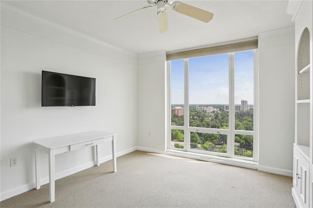 unfurnished living room with carpet, ornamental molding, and plenty of natural light