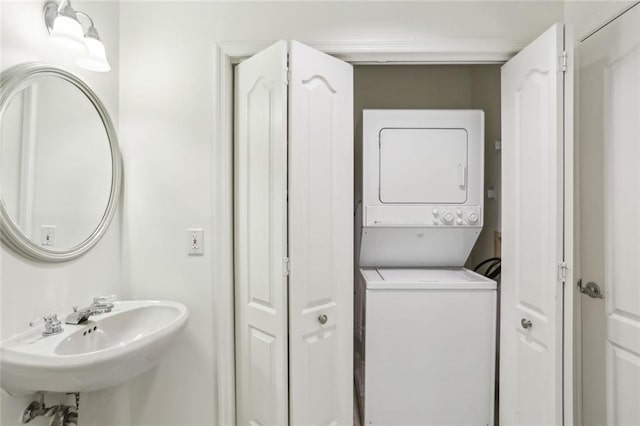 bathroom with a sink and stacked washer / drying machine