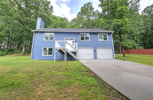 17 Fawn Ridge Dr SW, Cartersville, GA 30120 - bi-level home featuring concrete driveway, a garage, a chimney, and view of wooded area
