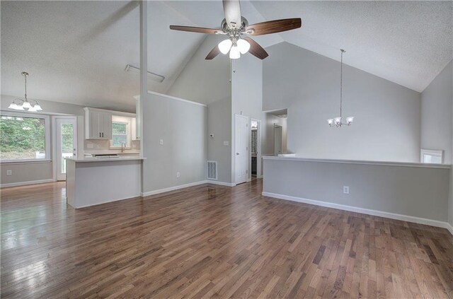 17 Fawn Ridge Dr SW, Cartersville, GA 30120 - unfurnished living room with a chandelier, high vaulted ceiling, ceiling fan, wood finished floors, and a textured ceiling