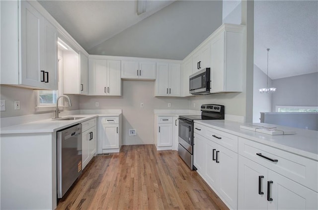 17 Fawn Ridge Dr SW, Cartersville, GA 30120 - kitchen with stainless steel appliances, lofted ceiling, white cabinetry, light wood finished floors, and a chandelier