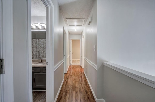 17 Fawn Ridge Dr SW, Cartersville, GA 30120 - corridor featuring wood finished floors, a textured ceiling, and attic access