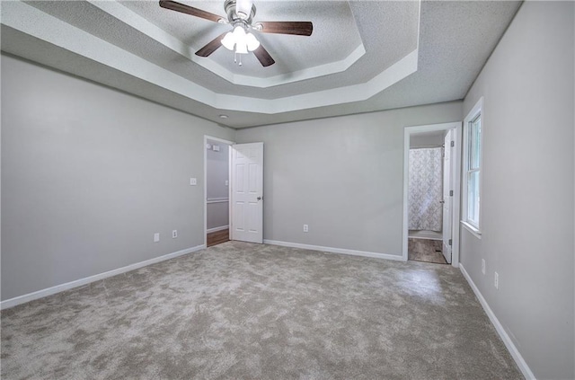 17 Fawn Ridge Dr SW, Cartersville, GA 30120 - unfurnished bedroom with a textured ceiling, carpet floors, a raised ceiling, ensuite bathroom, and ceiling fan