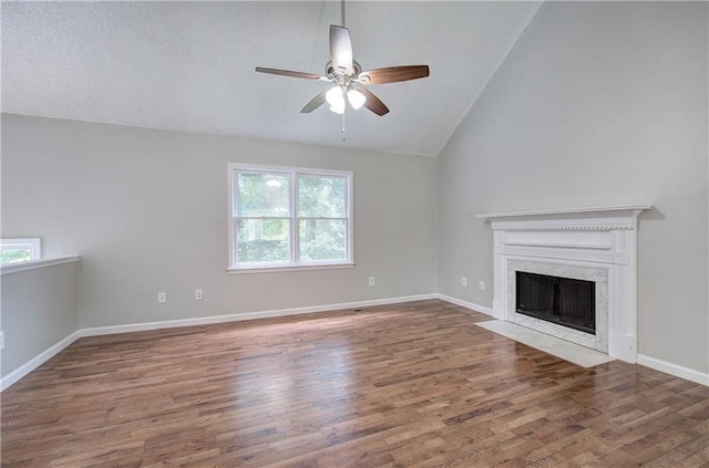 17 Fawn Ridge Dr SW, Cartersville, GA 30120 - unfurnished living room with ceiling fan, lofted ceiling, wood finished floors, and a fireplace
