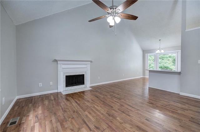 17 Fawn Ridge Dr SW, Cartersville, GA 30120 - unfurnished living room featuring high vaulted ceiling, a ceiling fan, a chandelier, wood finished floors, and a premium fireplace