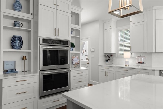1374 Riverside Dr, Gainesville, GA 30501 - kitchen with open shelves, stainless steel double oven, white cabinetry, and backsplash