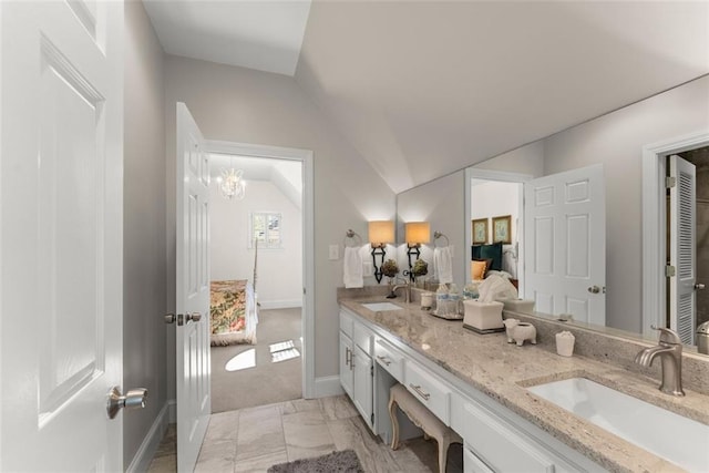 1374 Riverside Dr, Gainesville, GA 30501 - bathroom with double vanity, vaulted ceiling, connected bathroom, baseboards, and a chandelier