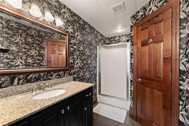 1374 Riverside Dr, Gainesville, GA 30501 - full bathroom featuring wallpapered walls, a stall shower, vanity, tile patterned flooring, and a paneled ceiling
