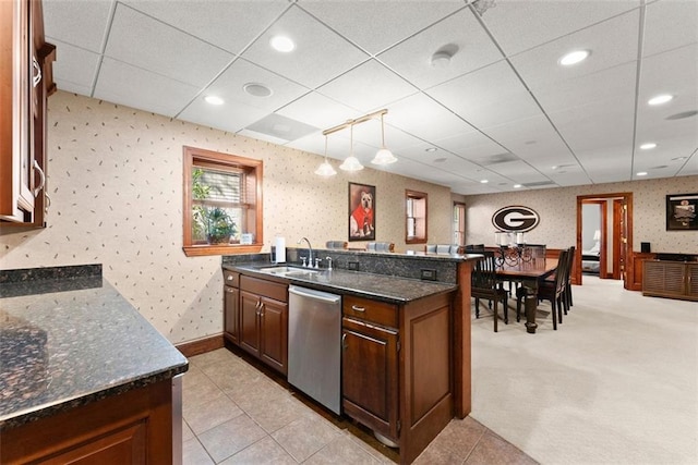 1374 Riverside Dr, Gainesville, GA 30501 - kitchen featuring dishwasher, a sink, wallpapered walls, dark stone counters, and a paneled ceiling