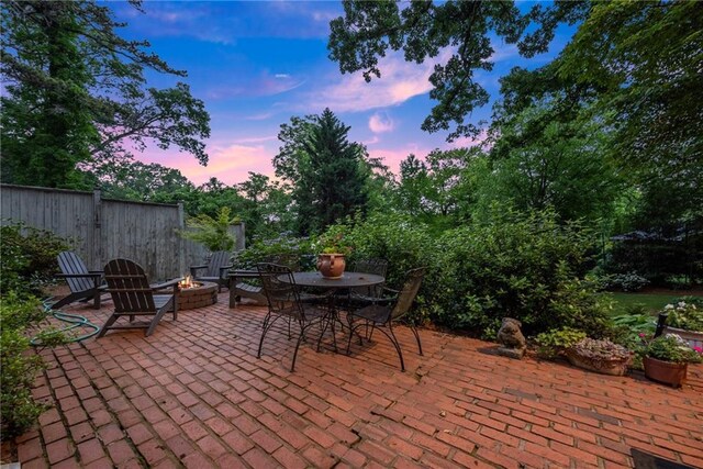 1374 Riverside Dr, Gainesville, GA 30501 - patio terrace at dusk with a patio area, an outdoor fire pit, and outdoor dining space