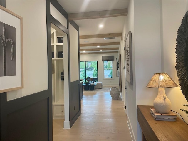 hallway featuring beam ceiling and light wood-type flooring