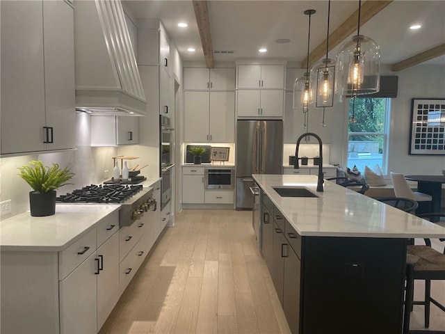 kitchen featuring a large island, beamed ceiling, and stainless steel appliances