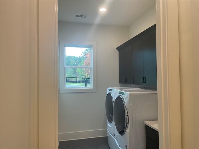 clothes washing area featuring washing machine and dryer, recessed lighting, visible vents, baseboards, and cabinet space